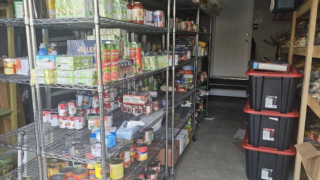 Shelves stocked with canned goods and food supplies inside one of Rozi Roti's garage storage spaces