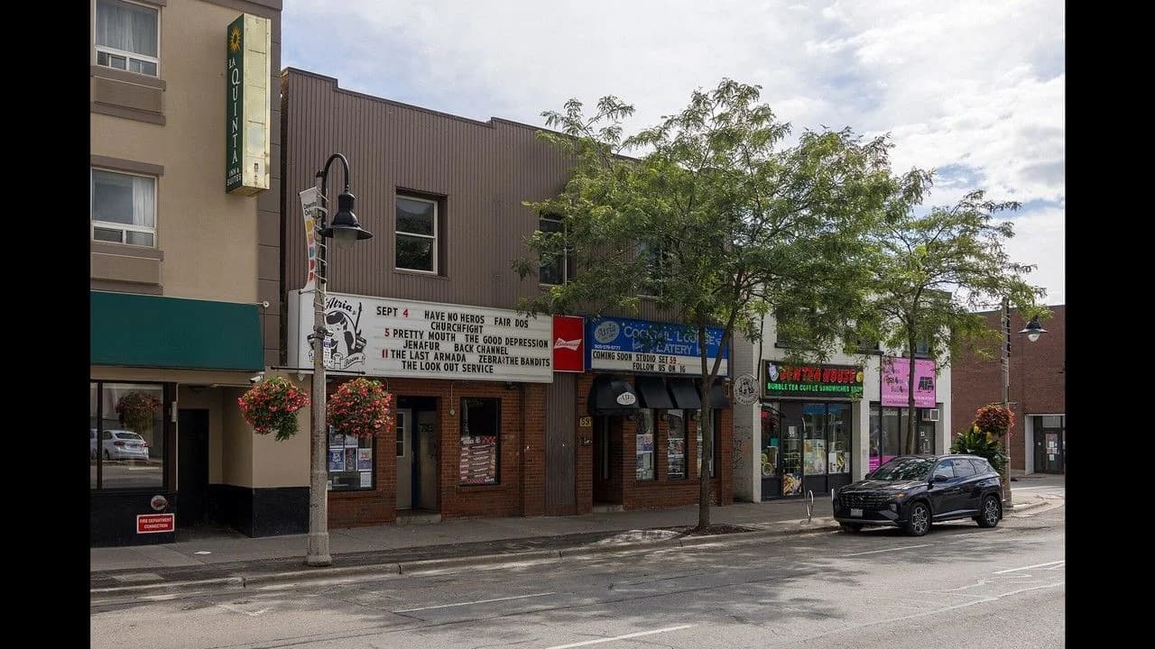 Downtown Oshawa storefront streetscape in daylight; no people.