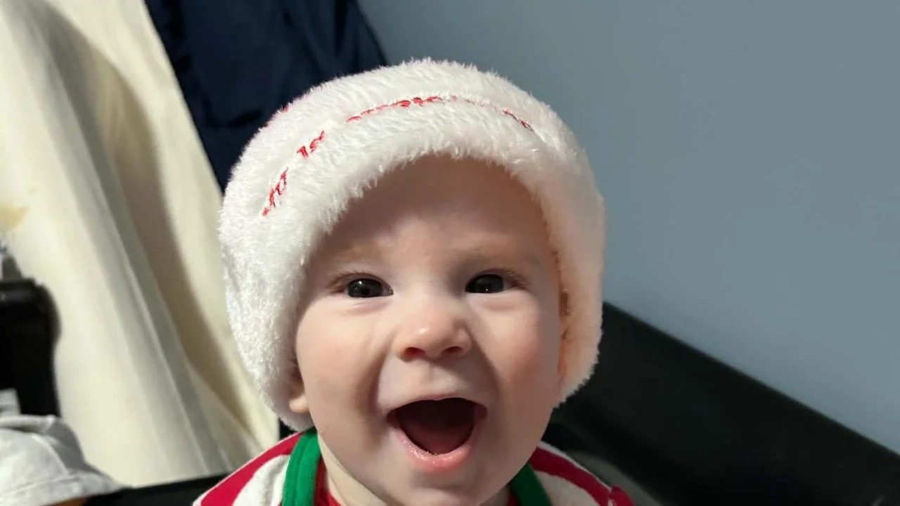 15-month-old Henry Roach of Bowmanville smiling in a Team Canada hockey jersey