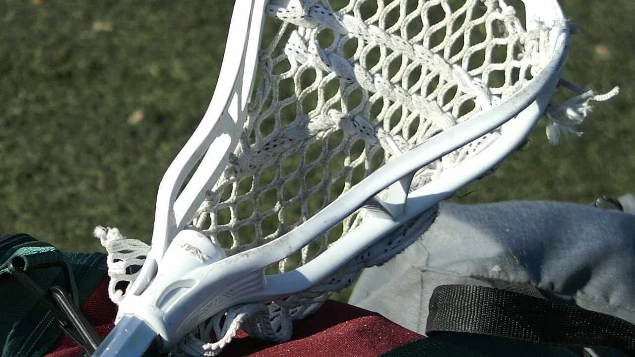 A white lacrosse head with netting; no people visible.