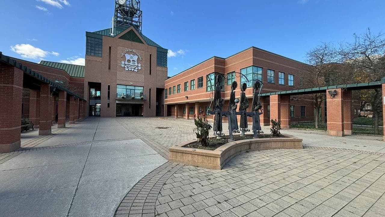 Pickering City Hall civic building and clock tower under a clear sky; no people visible